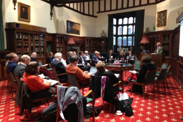 Photo of older people participating in a workshop in a wood-panelled room
