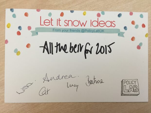 A notecard is pictured reading 'let it snow ideas' with colorued snow dots on the top half of the card. It says 'all the best for 2015' and is signed by Andrea, Beatrice, Cat, Lucy and Lisa