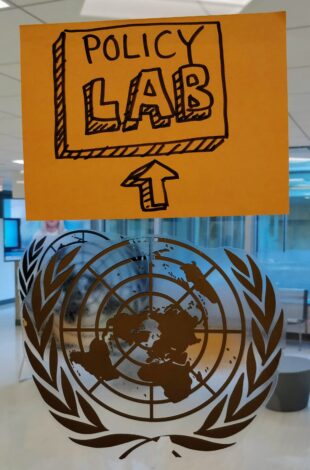 A picture of the Policy Lab logo (a square with 'Policy Lab' written within) alongside the UN logo in a pop up setting. 