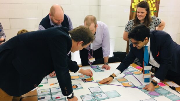 A group of people at a workshop building an evidence map