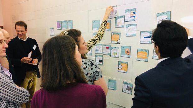 A group of people at a workshop discussing Geospatial evidence cards