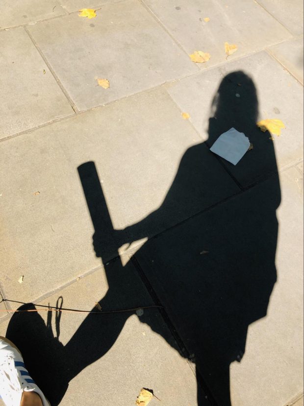 This is an image of the author's own shadow on the pavement whilst out on field research.