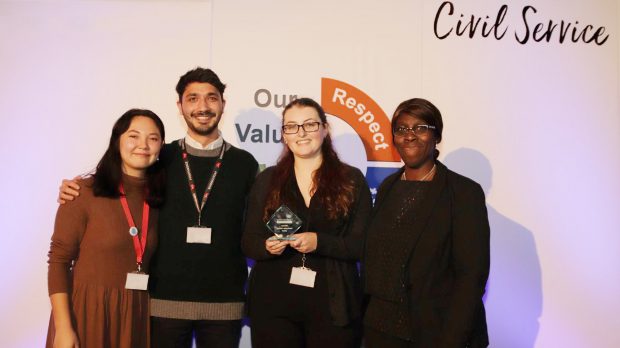 This is an image of the Policy Lab team, Nina Cutler and Sanjan Sabherwal, receiving the Cabinet Office Innovator Award from Carol Bernard with the policy lead Alice Weavers from the DCMS Youth Policy Team. 