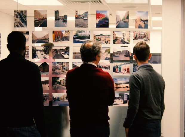 This is an image of workshop participants looking at a wall of crowd-sourced photos at a Policy Lab event on street design at the Chartered Institute of Highways and Transportation in 2019.