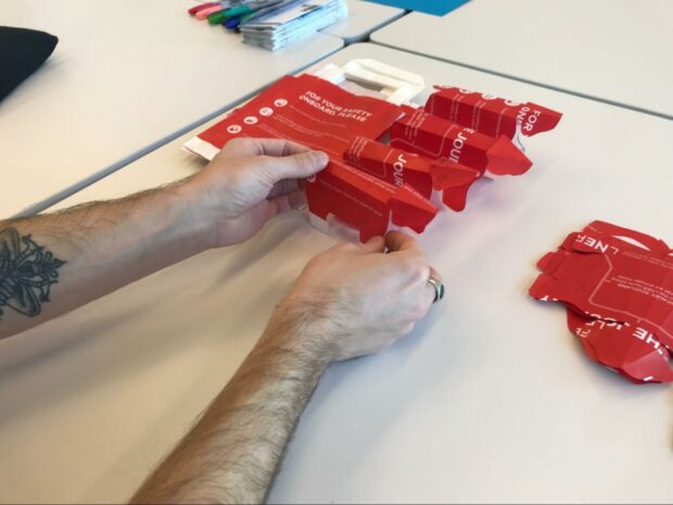 Photo of a member of the Policy Lab team crafting origami polar bears from found materials for our workshop at the Design for Planet festival in Dundee.