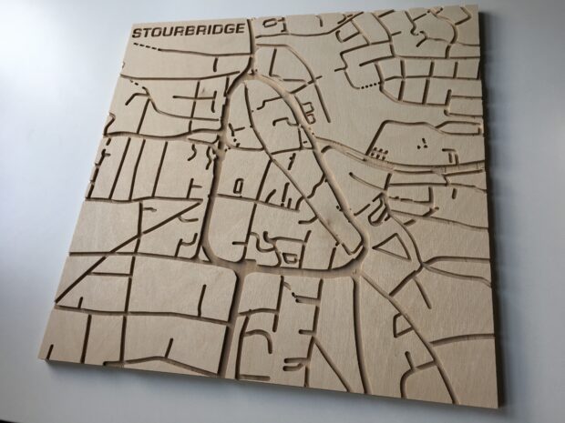 A square plank of wood with a map of roads etched into it local to Stourbridge